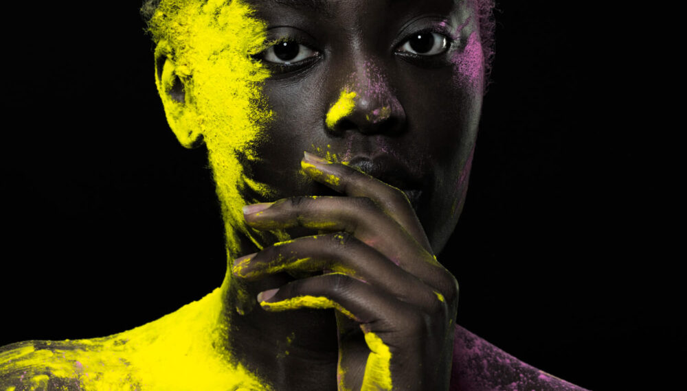 close-up-black-model-posing-with-yellow-powder-2